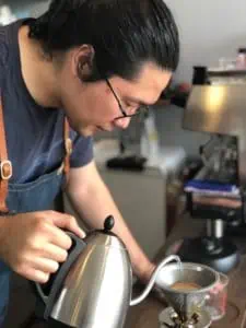 Image of Yen-Ying Chiu, of Back Home Coffee in Changhua County, Taiwan, cupping in his roastery.