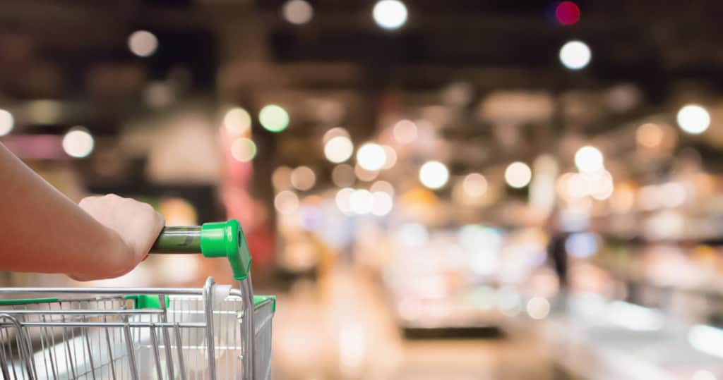 Shopper strolling the coffee aisle in a supermarket