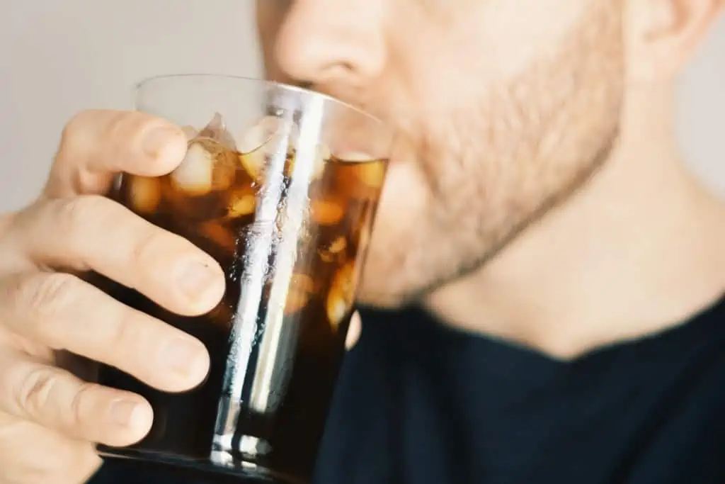 Photo of man enjoying iced coffee